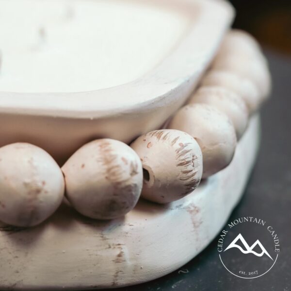 A close up of a bowl with beads on it