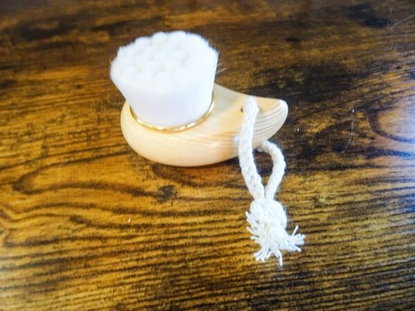 A wooden table with a white cup on top of it.