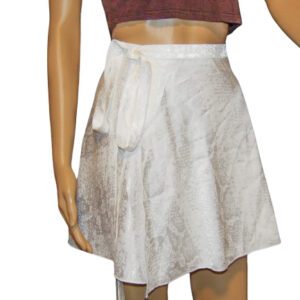 A woman wearing a white skirt and brown top.