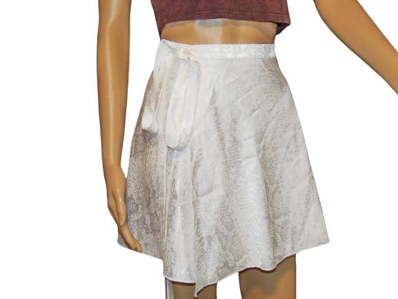 A woman wearing a white skirt and brown top.