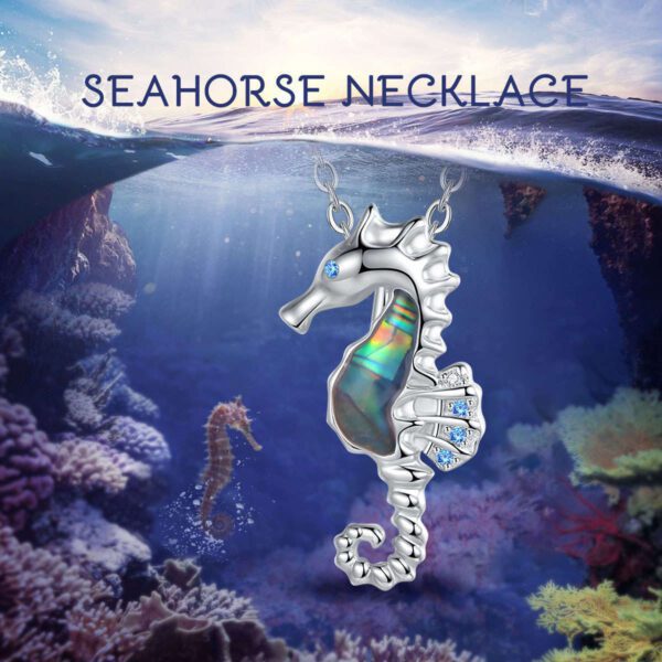 A seahorse necklace is shown in the ocean.