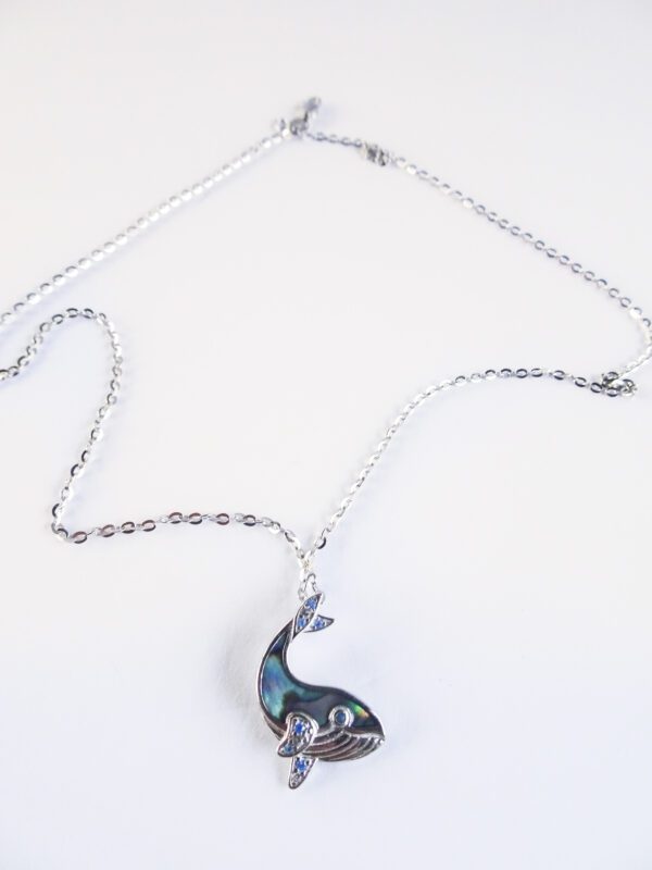 A silver chain with a blue and white pendant.