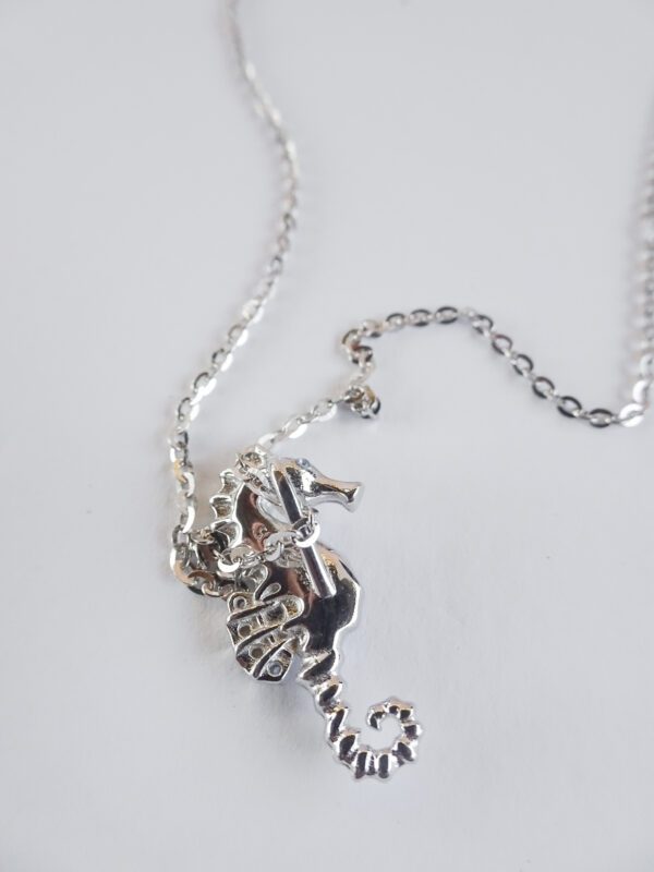 A silver chain with some charms on it