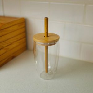 A cup with a straw on top of it.