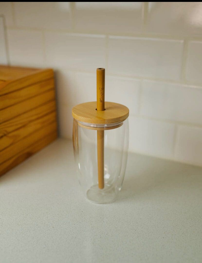 A cup with a straw on top of it.