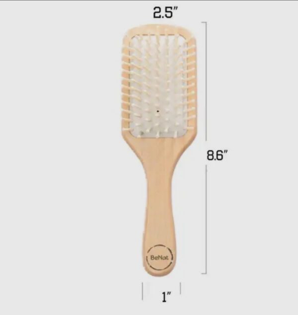 A wooden paddle brush with white bristles.