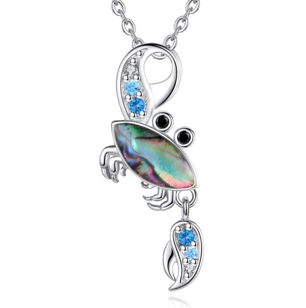 A silver necklace with an abalone crab pendant.