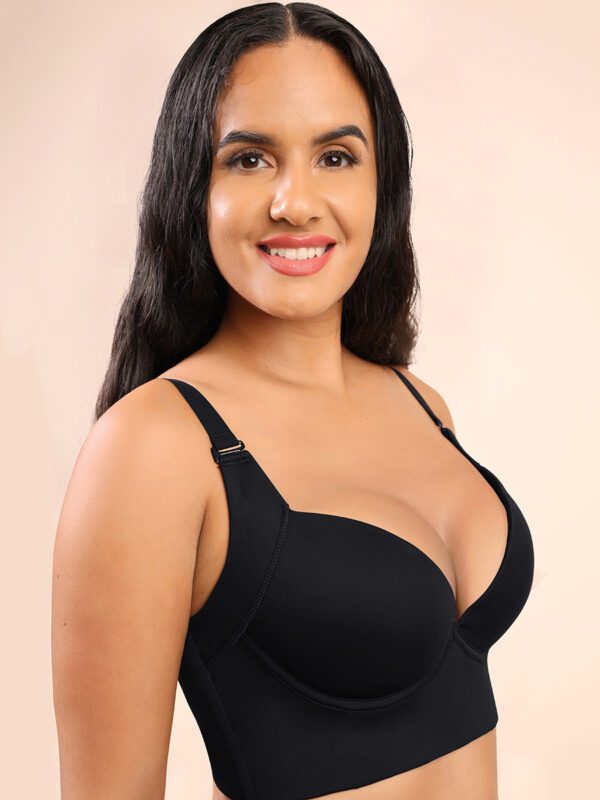 A woman in black bra smiling for the camera.