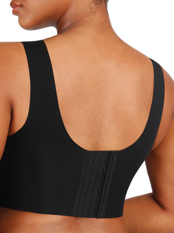 A woman wearing a black tank top with straps.