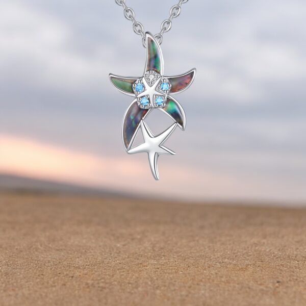 A necklace with two different colored starfish on it.