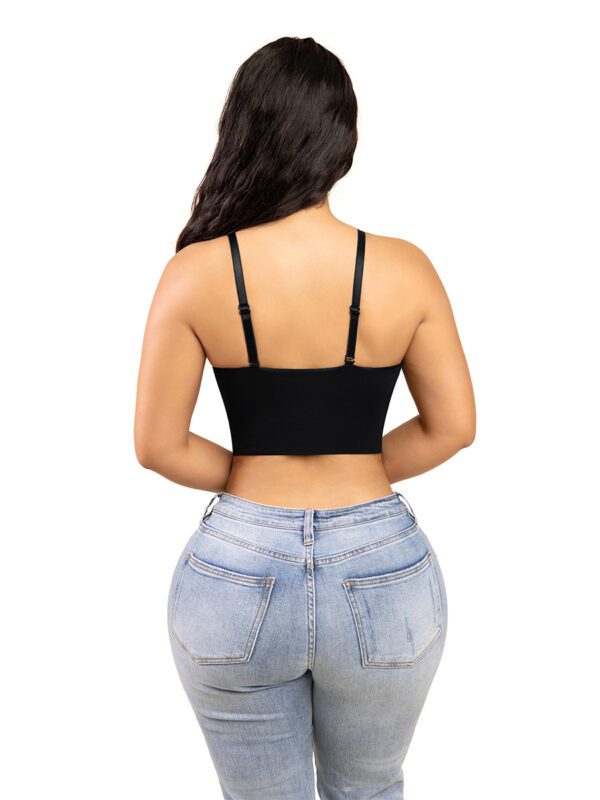 A woman wearing jeans and black bra top.