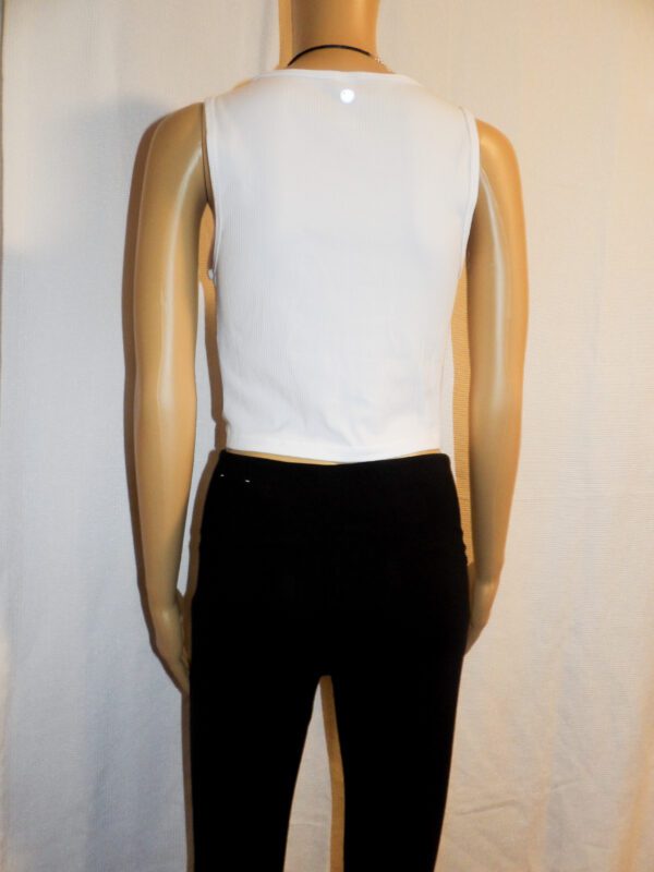 A mannequin wearing black pants and white shirt.