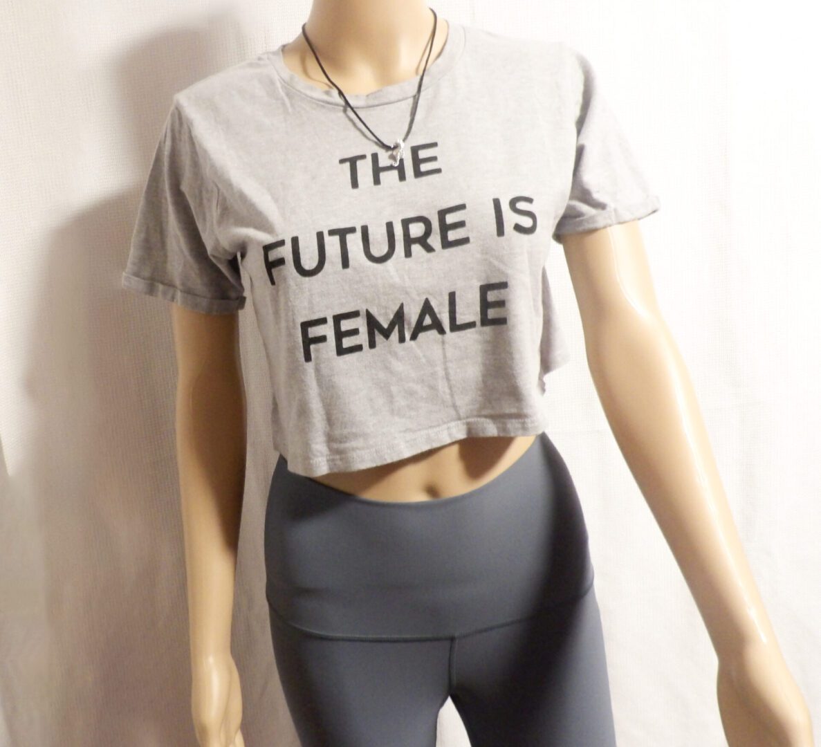 A mannequin wearing tight pants and a crop top.