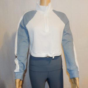 A mannequin wearing a white and blue jacket.