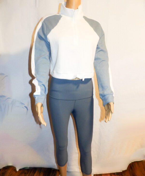 A mannequin wearing tight pants and a white shirt.