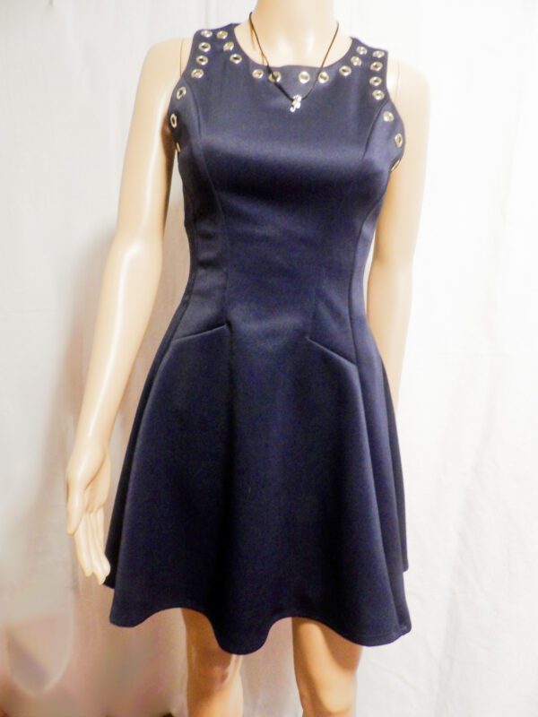 A mannequin wearing a black dress with a necklace.