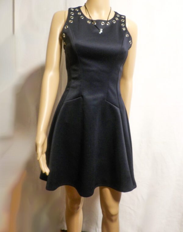 A mannequin wearing a black dress with lace trim.