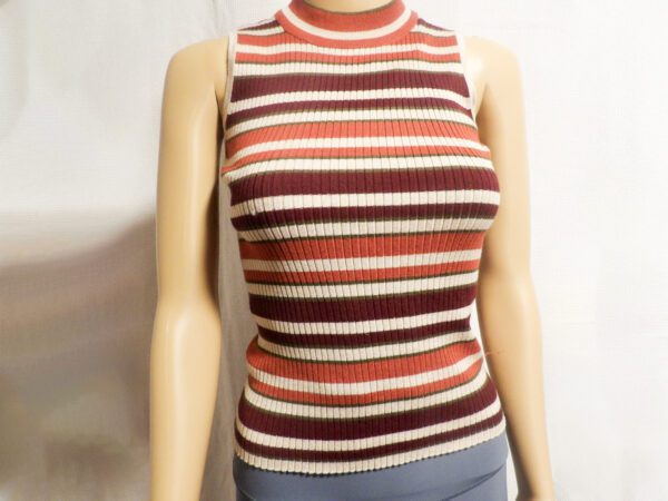 A mannequin wearing a striped sweater and jeans.