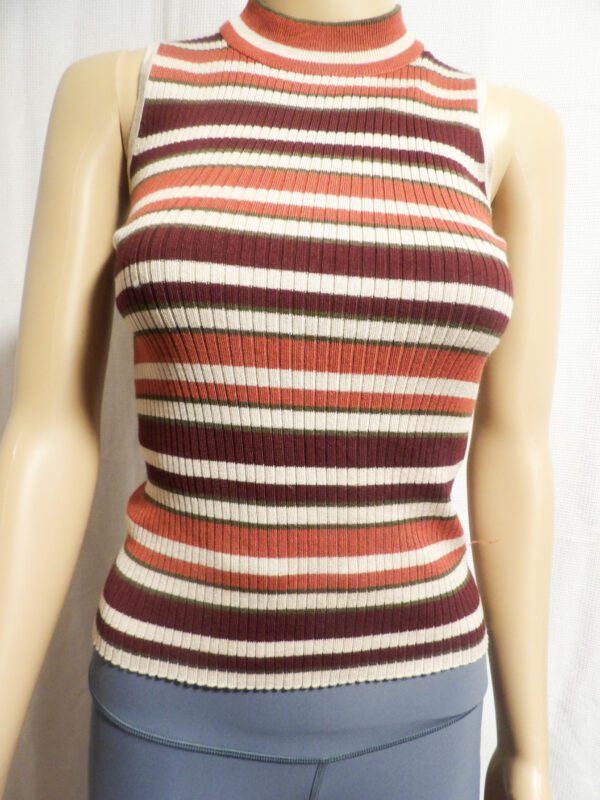 A woman wearing a striped sweater and jeans.