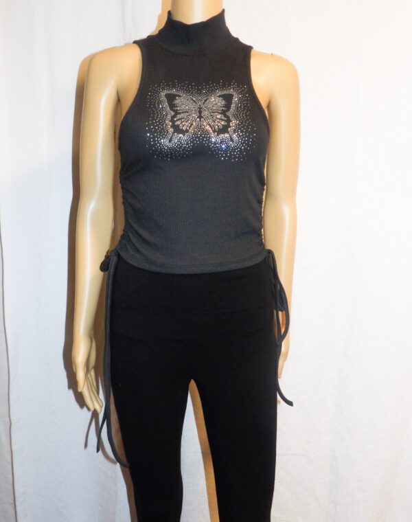 A mannequin wearing black pants and a top.