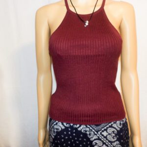 A mannequin wearing a red top and black skirt.