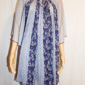 A woman wearing a dress with a floral pattern.