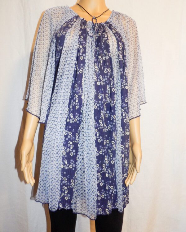 A woman wearing a dress with a floral pattern.
