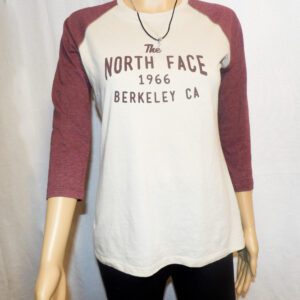 A person wearing a white and maroon shirt