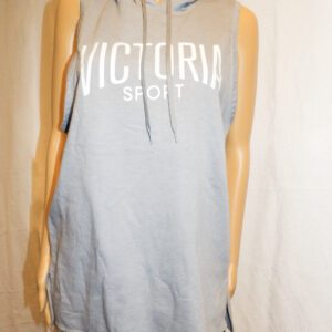 A woman wearing a grey victoria sport tank top.