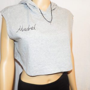 A woman wearing a gray crop top with the name isabel written on it.