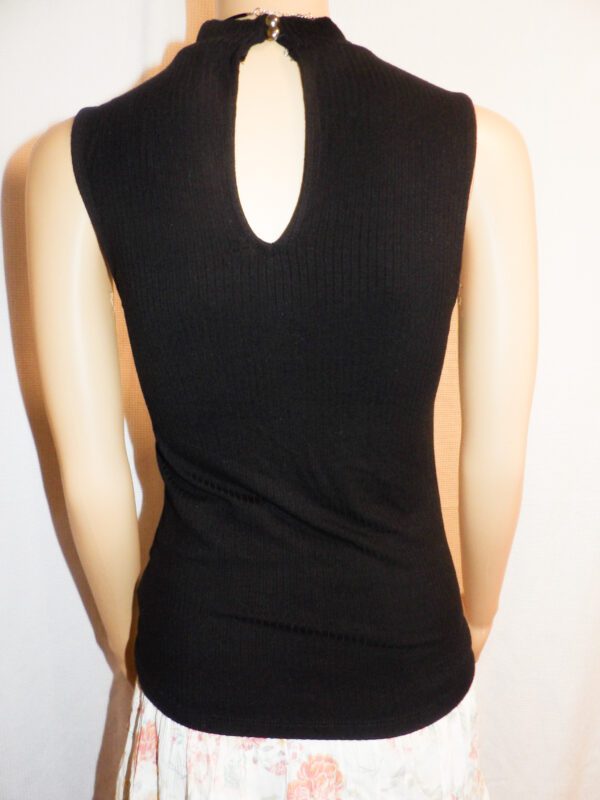 A woman wearing black tank top with a cut out back.