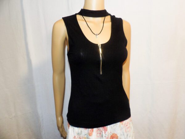 A black top with a gold chain necklace.