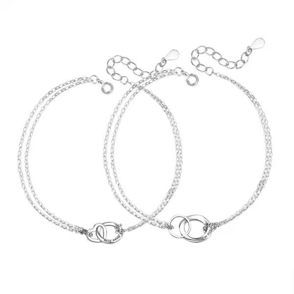 A pair of silver anklets with two different chains.