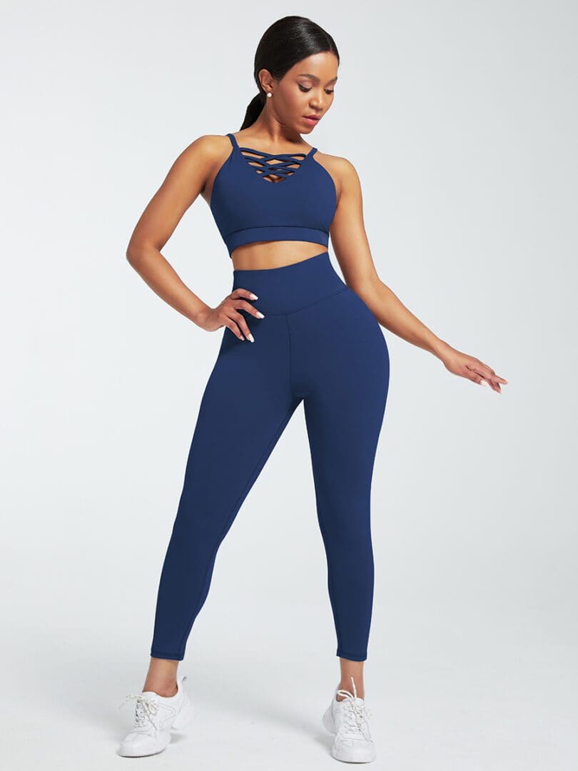 A woman in blue workout clothes posing for the camera.