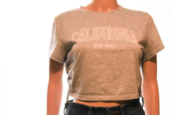 A woman wearing a gray t-shirt with the word california on it.