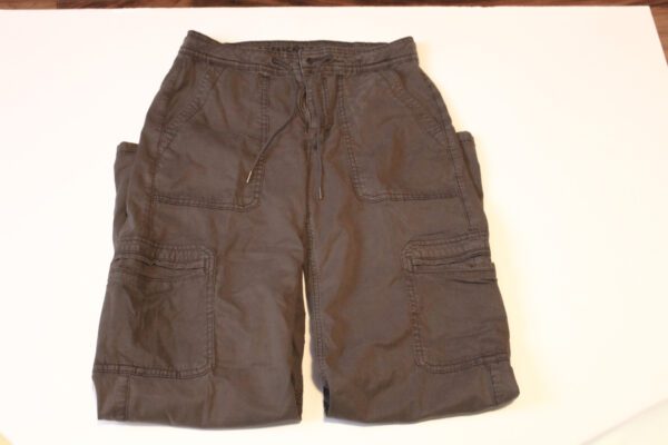 A pair of brown cargo shorts on top of a white surface.