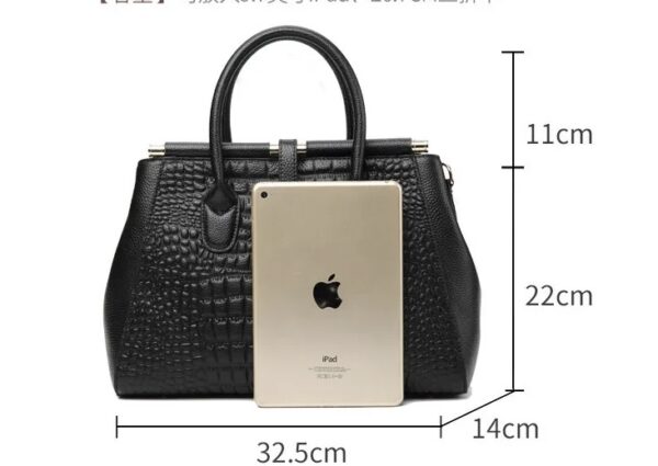 A black handbag with an apple logo on the side.