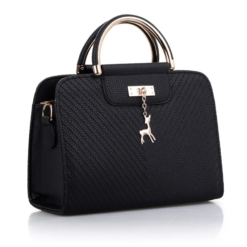 A black purse with a gold handle and a key.