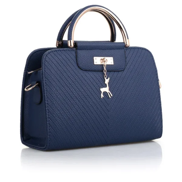 A blue purse with a deer charm on the front.