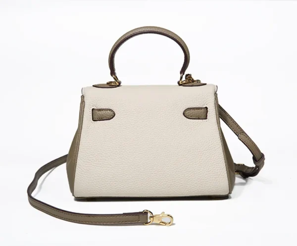 A white and brown purse with a strap.