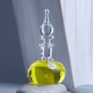 A glass bottle with oil inside of it