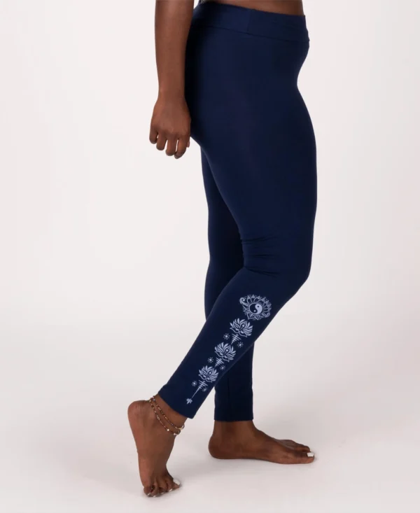 A person standing on their feet wearing yoga pants.