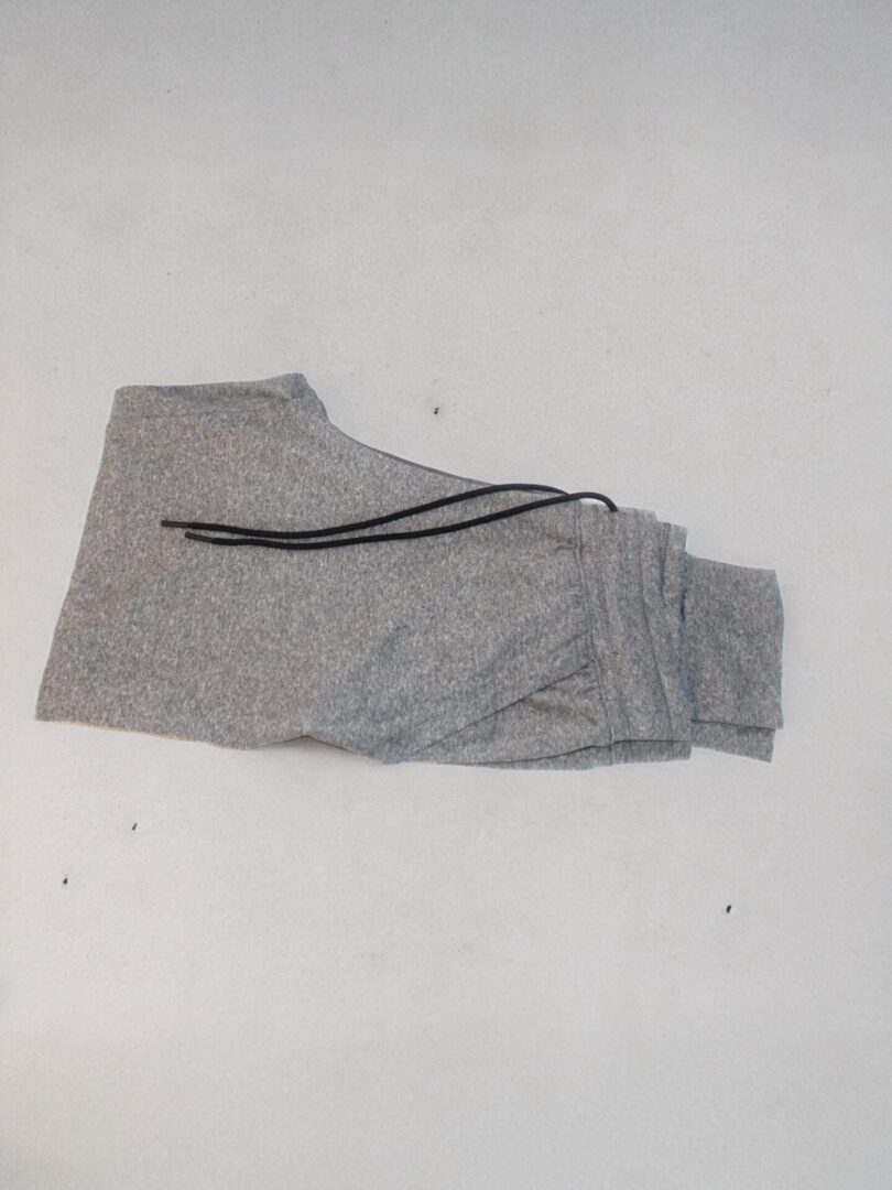 A pair of grey sweatpants on the floor.