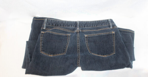 A pair of jeans are shown with the back pockets exposed.