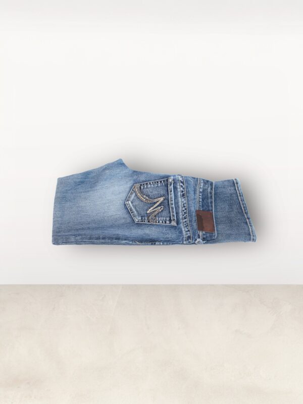 A pair of jeans that are folded up on the floor.