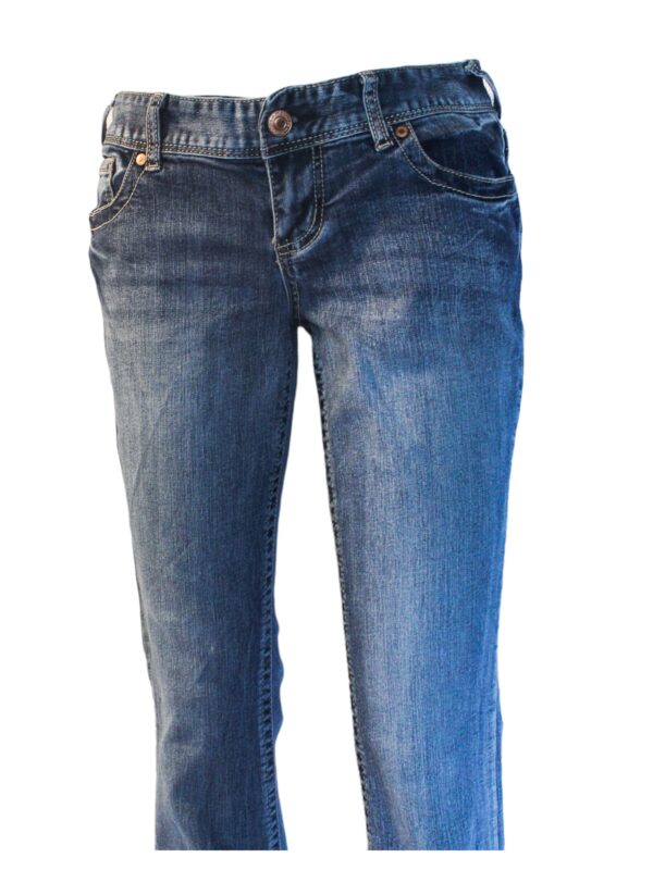 A pair of jeans are shown with one leg crossed.