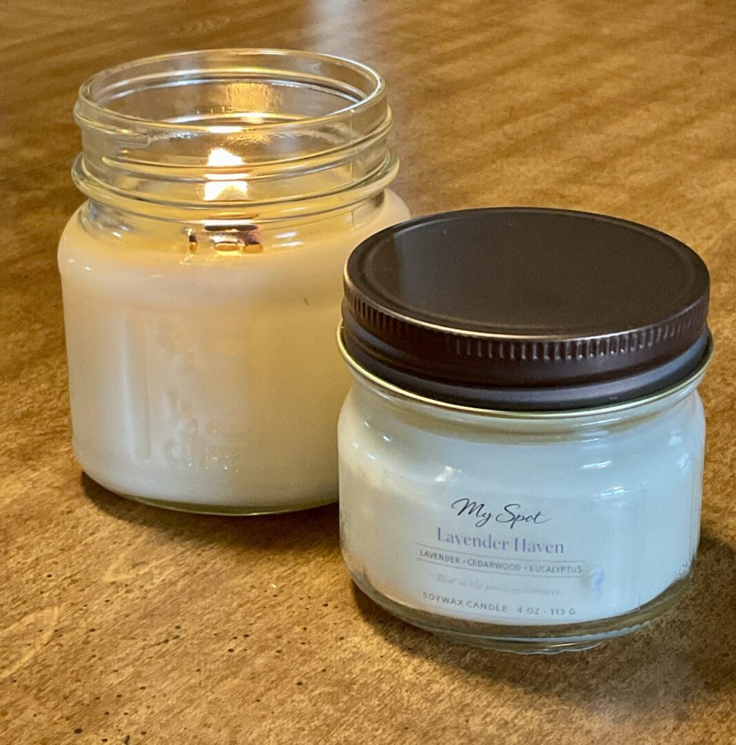 4oz nad 8oz soy candles showing size comparison and burning candle