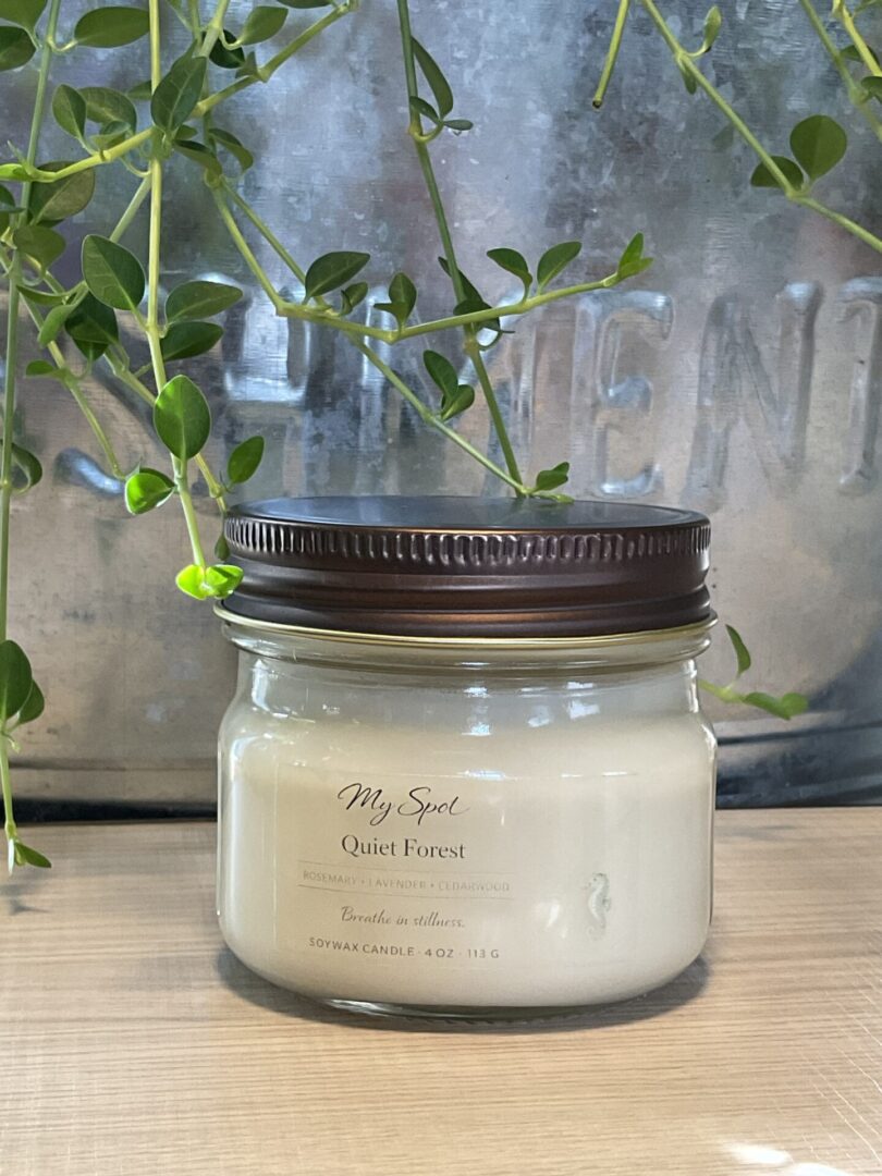 handmade soy candle quiet forest in glass jar with natural greenery