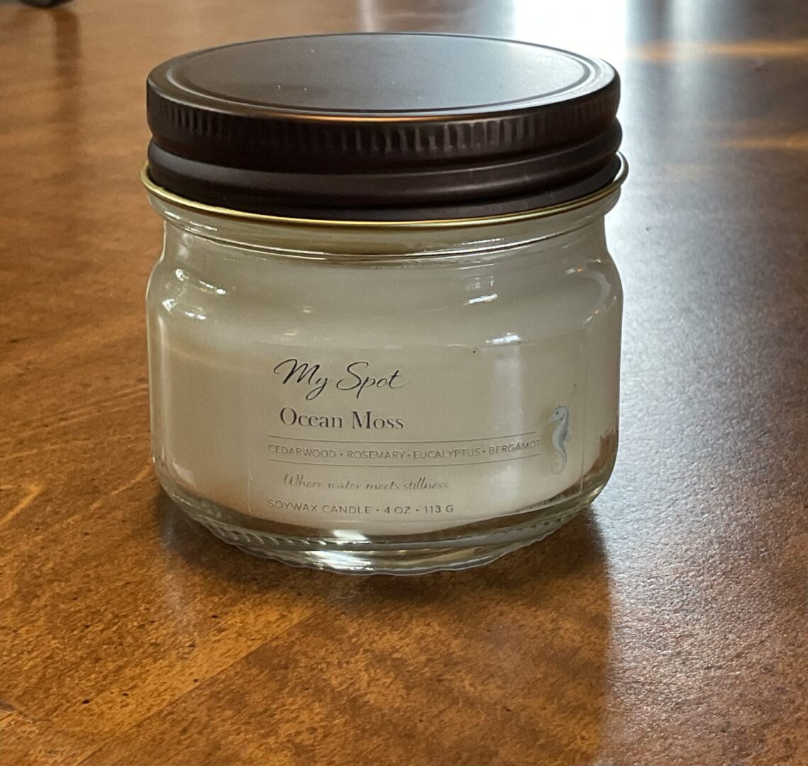 Ocean Moss soy candle on wooden surface cozy aesthetic handmade candle