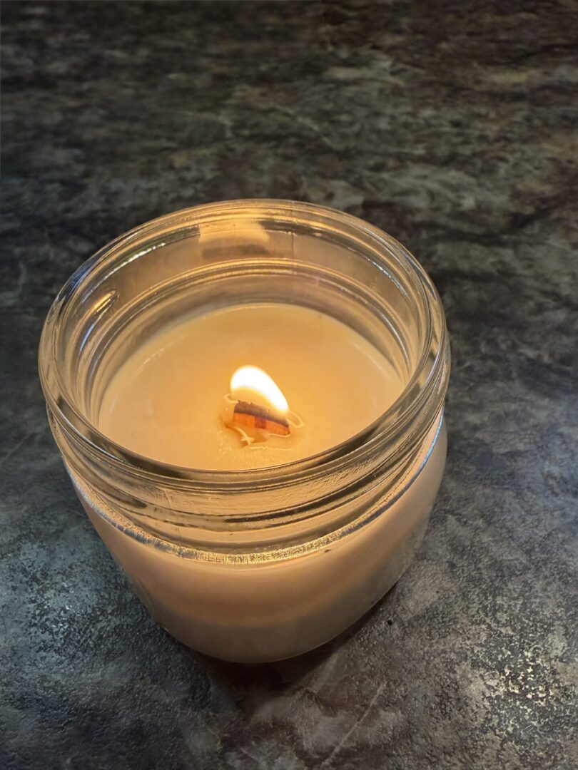 handmade soy candle quiet forest burning with wooden wick in glass jar